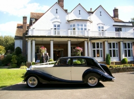 Ivory and black Rolls Royce wedding car in Egham